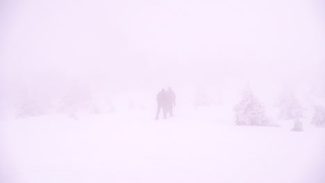 Snowshoe-hikers-walking-in-strong-blizzard-conditions-with-poor-visibility