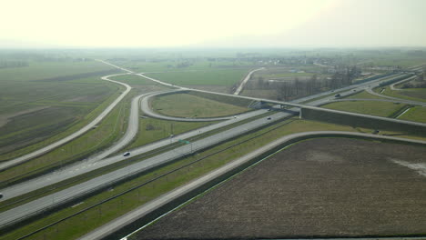 Aerial-view,-the-drone-flies-along-parallel-highway-roads-S7-Cdry-road-and-infinity-road-interchange-in-Poland