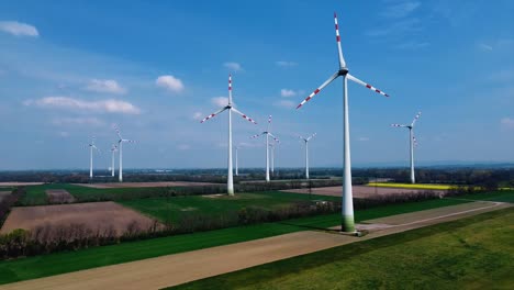 AERIAL---Wind-turbines-in-a-wind-energy-farm-in-Austria,-rising-wide-shot