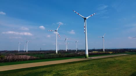 AERIAL---Wind-turbines-in-a-wind-energy-farm-in-Austria,-wide-shot-slow-forward