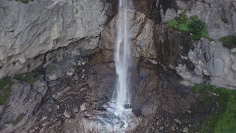 Rise-up-shot-of-waterfall-Almenbachfall-Berner-Oberland-Switzerland-drone-flight