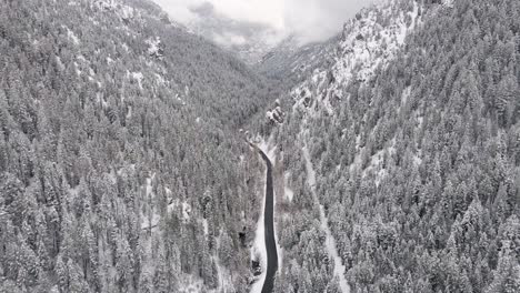 Cinematic-Aerial-Tilt-up-Reveal-of-Snowy-Winter-Scene-in-Utah-Mountains