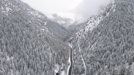 Aerial-view-over-snowy-American-Fork-Canyon-and-river-in-Utah's-Wasatch-Range