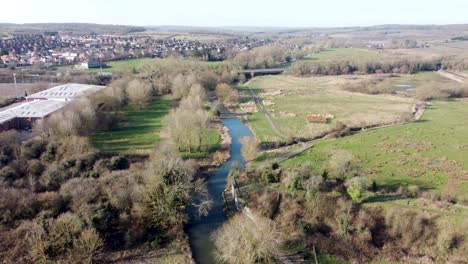 River-Stour-flowing-through-British-Chartham-Kent-countryside-aerial-rising-view