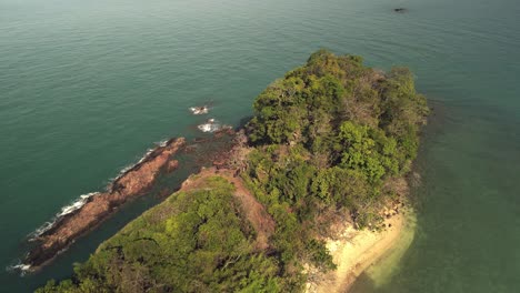 aerial-birds-eye-view-of-backwards-flying-drone-looking-down-on-uninhabited-tropical-island
