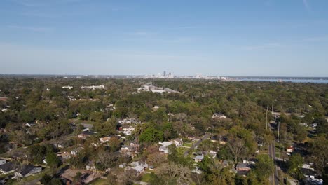 Aerial-view-over-the-Murray-Hill-area,-Jacksonville-skyline-in-the-background---reverse,-drone-shot
