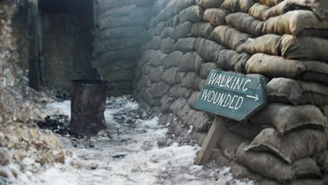 A-walking-wounded-sign-in-a-ww1-trench-with-sand-bags-and-a-troop-fire-next-to-a-first-world-war-dug-out
