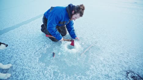 Making-a-hole-on-a-frozen-lake-for-ice-fishing