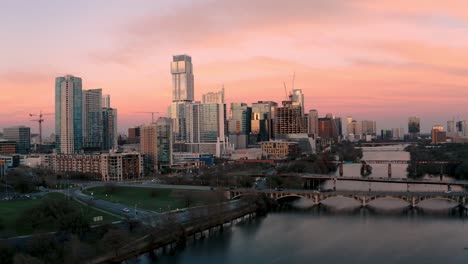 Austin-Texas-Skyline-at-sunset-aerial-drone-flying-over-town-lake-and-Lamar-bridge-in-4k