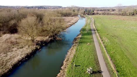 Idyllic-Stour-walk-British-River-Stour-Chartham-rural-landscape-aerial-rising-shot-above-green-Kent-countryside