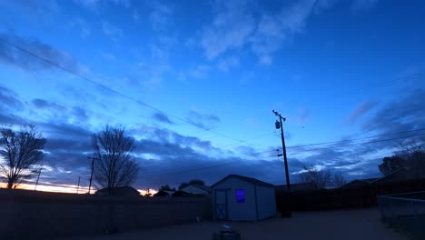 Dawn-breaks-over-a-suburban-neighborhood---night-to-day-time-lapse