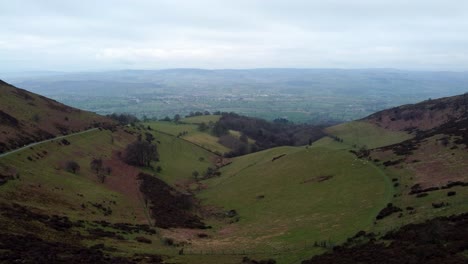 Clwydian-range-rural-mountain-valley-countryside-terrain-aerial-view-across-hiking-wilderness-dolly-left