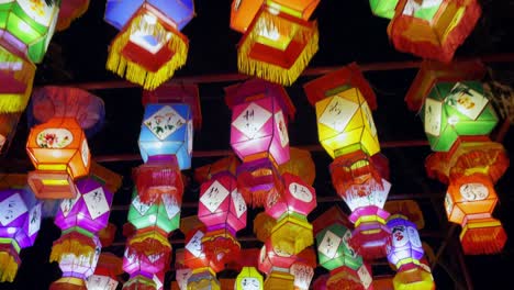 Walking-under-colorful-Chinese-hanging-lanterns-lit-up-at-night