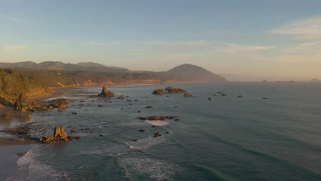 Drone-flies-over-sea-stacks-in-Port-Orford-during-warm-afternoon-light