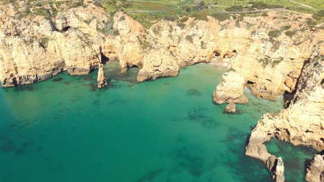 Barranco-do-Martinho-Beach-near-Ponta-da-Piedade,-Lagos-Algarve,-Portugal---Aerial-wide-panoramic-establishing-shot