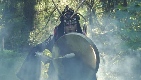 Shaman-walks-in-the-forest,-plays-the-drum