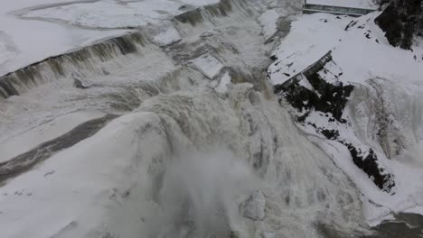 Majestic-Waterfalls-Flowing-Into-Frosted-Rocks-At-Chaudiere-Falls-Park-In-Levis,-Quebec-Canada