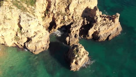 Rocky-Formations-and-erosion-Grottos-in-Ponta-da-Piedade-Lagos-Algarve---Aerial-Top-view-Rotation-shot