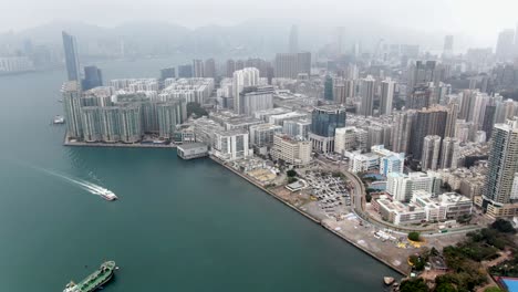 Hong-Kong-bay-coastline-and-waterfront-skyscrapers,-Aerial-view