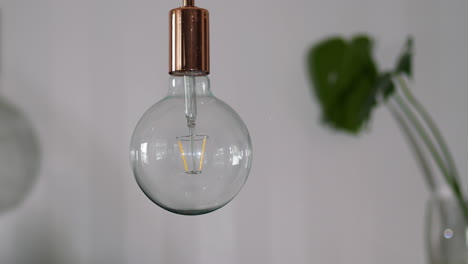 Light-bulb-showing-tungsten-filament-on-white-background