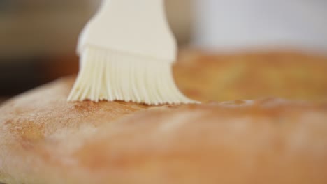 White-Brush-Cover-Pizza-Crust-with-Oil,-Selective-Focus-with-Copy-Space