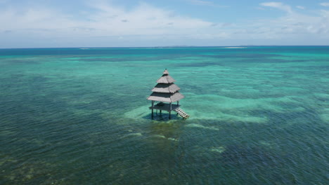 Aerial-showing-fisherrman-house-on-stilts-in-the-sea-nearby-General-Luna-on-Siargao-Island,-Philippines