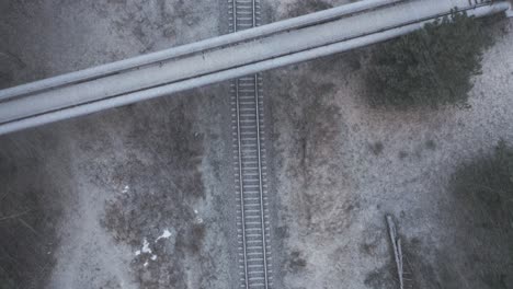 AERIAL:-Top-View-of-Overpass-Bridge-with-Railway-on-a-Snowstorm