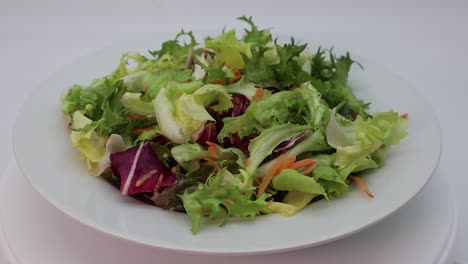 Fresh-mixed-green-salad-in-a-bowl-rotating