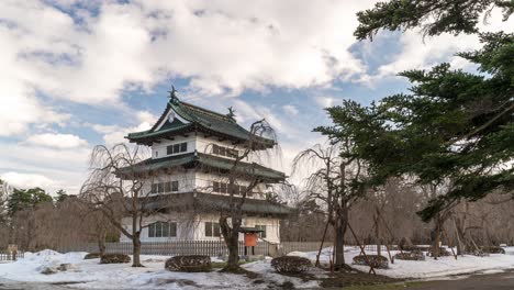 Wide-open-timelapse-of-wintery-snowed-in-Hirosaki-castle-in-Aomori,-Japan