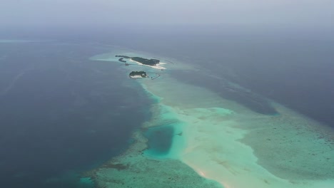 Aerial-View-of-isolated-island-of-Maldives-,-Indian-Ocean,-Exotic-Tropical-Destination,-Drone-Shot