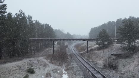 AERIAL:-Overpass-Bridge-over-the-Railway-on-a-Snowy-Day
