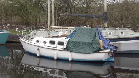 Small-sailboats-floating-on-rural-countryside-canal-marina