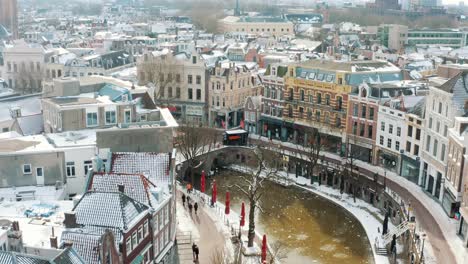 Aerial---Oudegracht-canal-frozen-in-winter-in-Utrecht,-Netherlands,-wide-shot