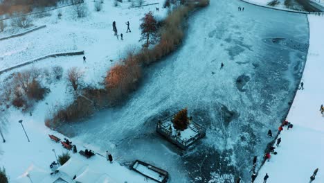Aerial-View-of-People-on-Frozen-Lake-Ice-Skating-on-Cold-Winter-Day,-Utrecht,-Netherlands