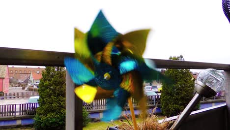 Plastic-pinwheel-rotate-color,-windmill-with-blowing-a-wind-against-sky-cinematic