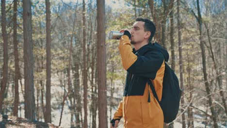 The-Hiker-in-the-forest-drinks-water-from-the-bottle-4K
