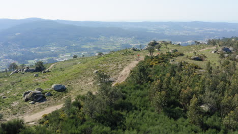 Mountain-Bikers-gathering-in-Northern-Portuguese-Mountain-top-trail---Aerial-Wide-Panoramic-shot