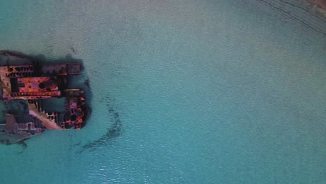 4K-overhead-moving-sideways-clip-over-a-shipwreck-in-the-tropical-beach-of-Epanomi,-Norhtern-Greece