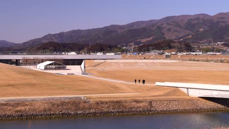 Slow-pan-over-group-of-tourists-walking-grounds-of-Iwate-Tsunami-Memorial-Museum
