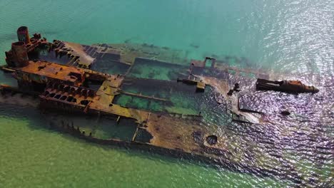 4K-tilt-up-clip-over-a-shipwreck-in-the-tropical-beach-of-Epanomi,-Norhtern-Greece