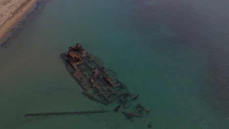 4K-tilt-up-clip-over-a-shipwreck-in-the-tropical-beach-of-Epanomi,-Norhtern-Greece