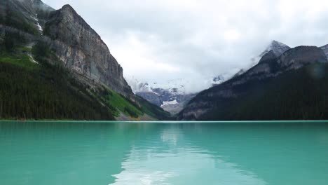 Lake-Louise,-Banff-Canada,-beautiful-clear-lake-between-huge-mountains-and-forests,-wide-view
