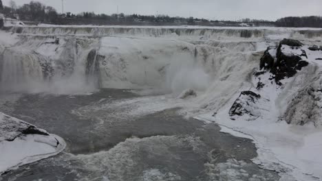 Overflowing-Streams-In-Frosted-Rugged-Cliffs-During-Winter-At-Chaudiere-Falls-Park-In-Levis,-Quebec-Canada---aerial-drone-shot