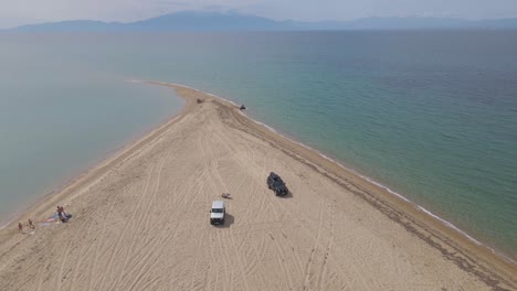 4k-slowly-moving-backward-clip-over-a-peninsula-on-the-tropical-beach-of-Epanomi,-Halkidiki,-Greece