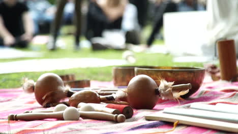 Traditional-percussion-instruments,-blurry-people-meditating-in-the-background