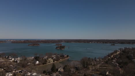 Left-to-right-pan-of-Crow-Point,-a-neighborhood-in-Hingham,-MA-USA,-showing-the-waterfront-and-harbor-islands