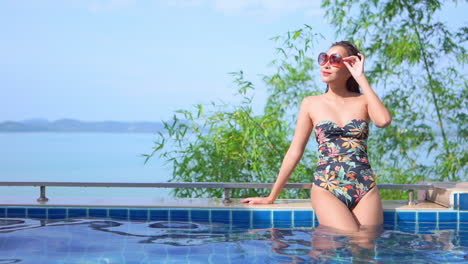 Sensual-tall-asian-model-enjoying-a-vacation-poolside