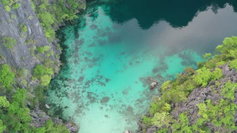Aerial-top-view-of-limestone-karst-scenery-and-turquoise-ocean-water-in-Coron-Island,-Palawan,-Philippines