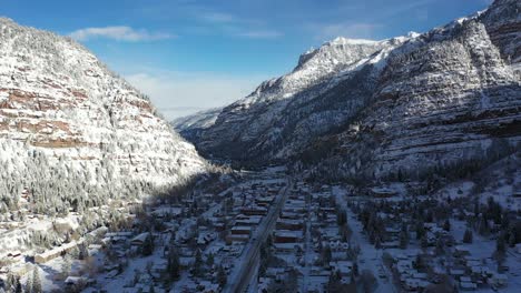 Ouray,-Southwestern-Colorado,-USA,-Aerial-View-of-Valley-Town-Under-Snow-Capped-Hills-of-San-Juan-Mountains,-Switzerland-of-America