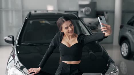 happy-nice-girl-taking-selfie-on-smartphone-with-new-car
